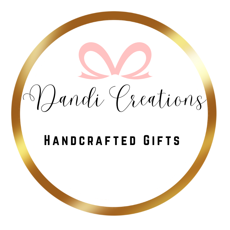 Dandi Gift Cards logo with pink ribbon and gold circular border for handcrafted gifts