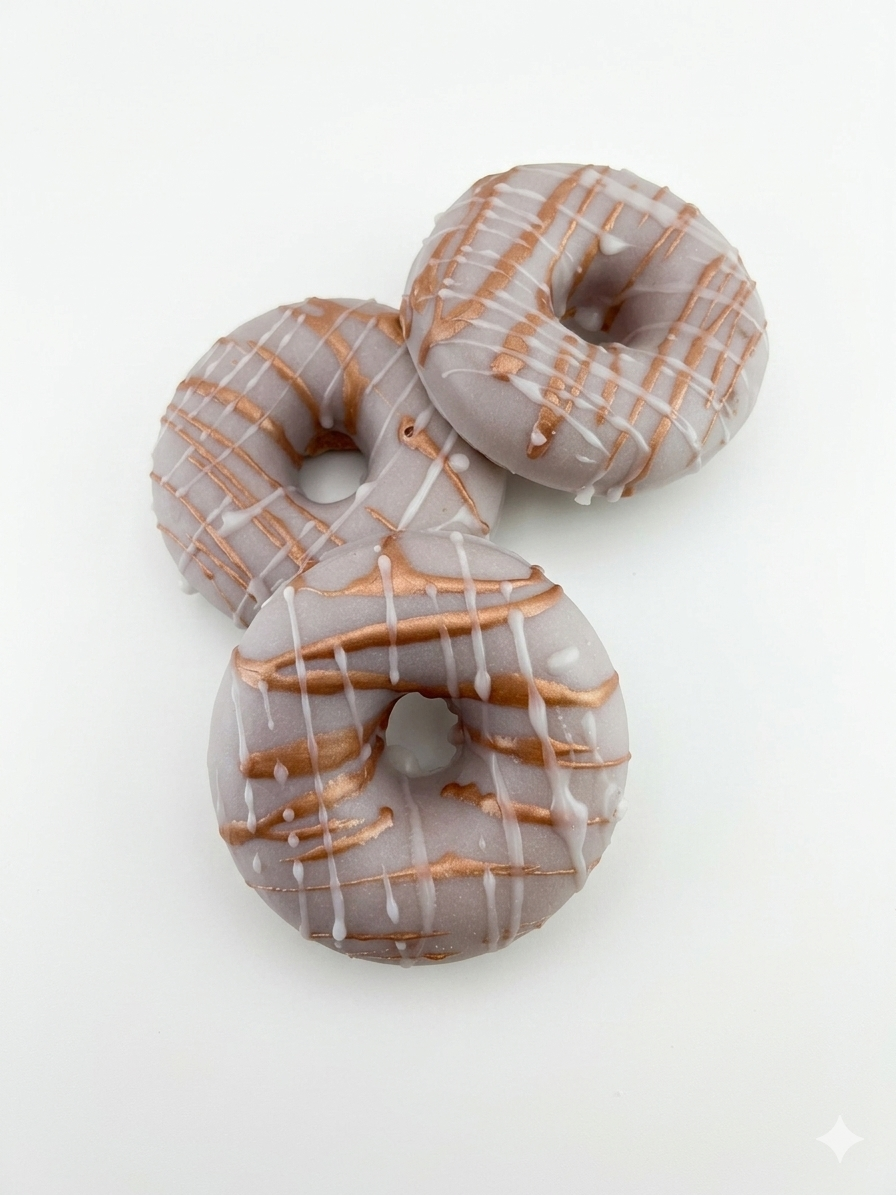 Three donuts with glaze on a white background