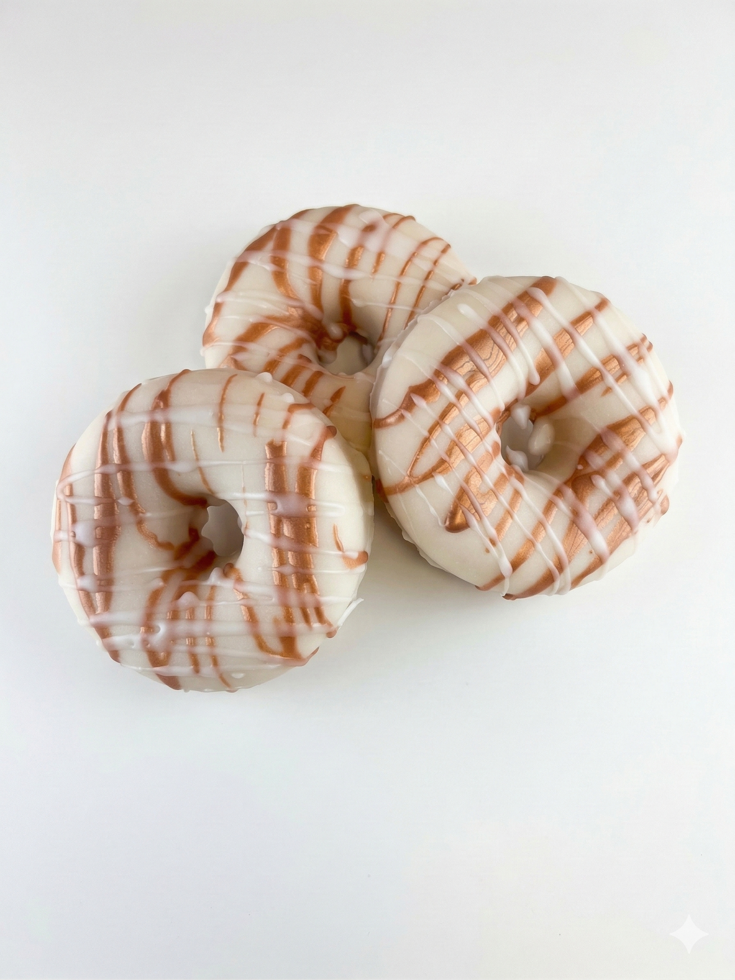 Two donuts with a brown and white glaze on a white background