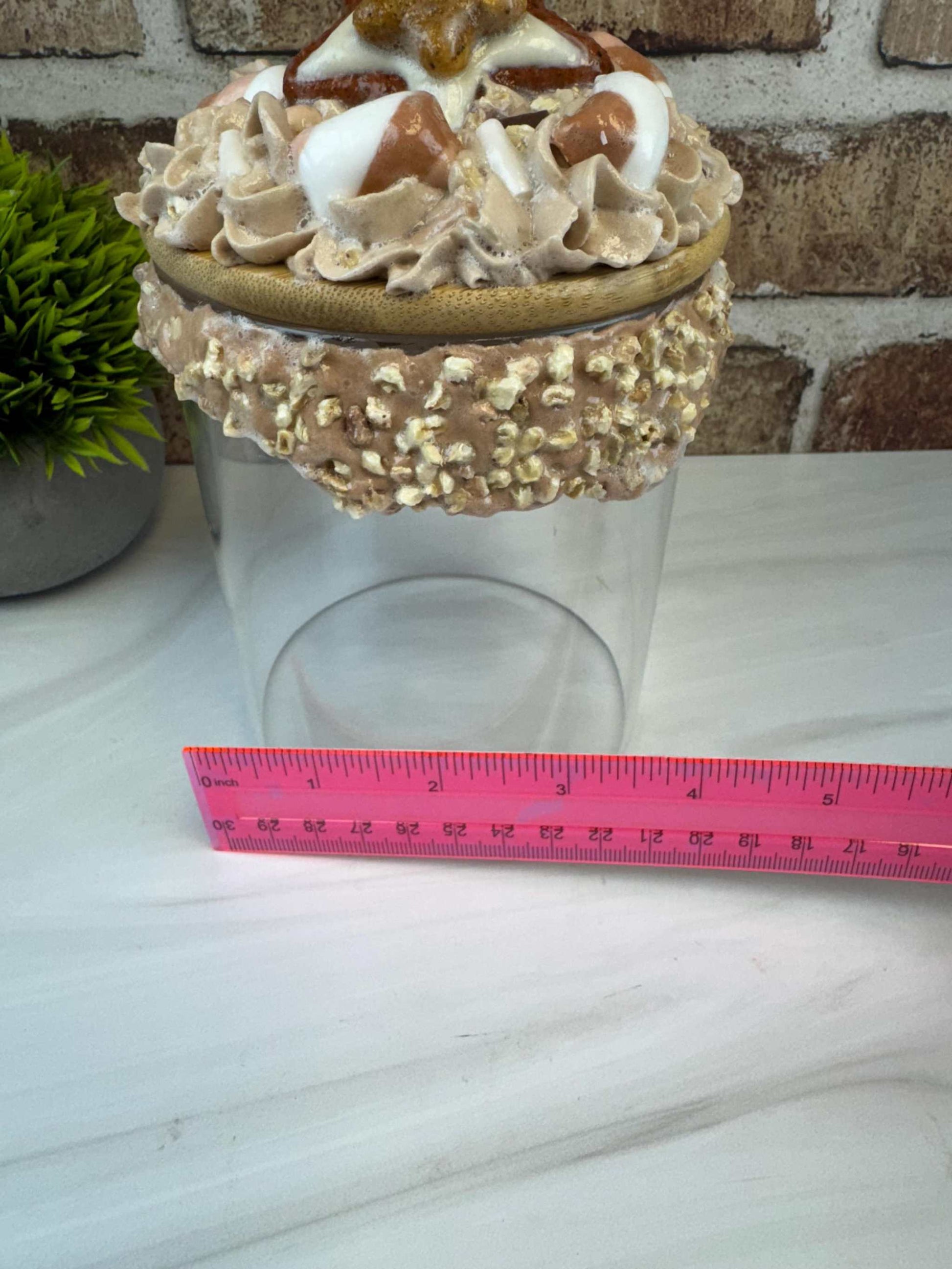 Sweet treat jar with faux whipped topping and decorative fake nuts for cookie storage