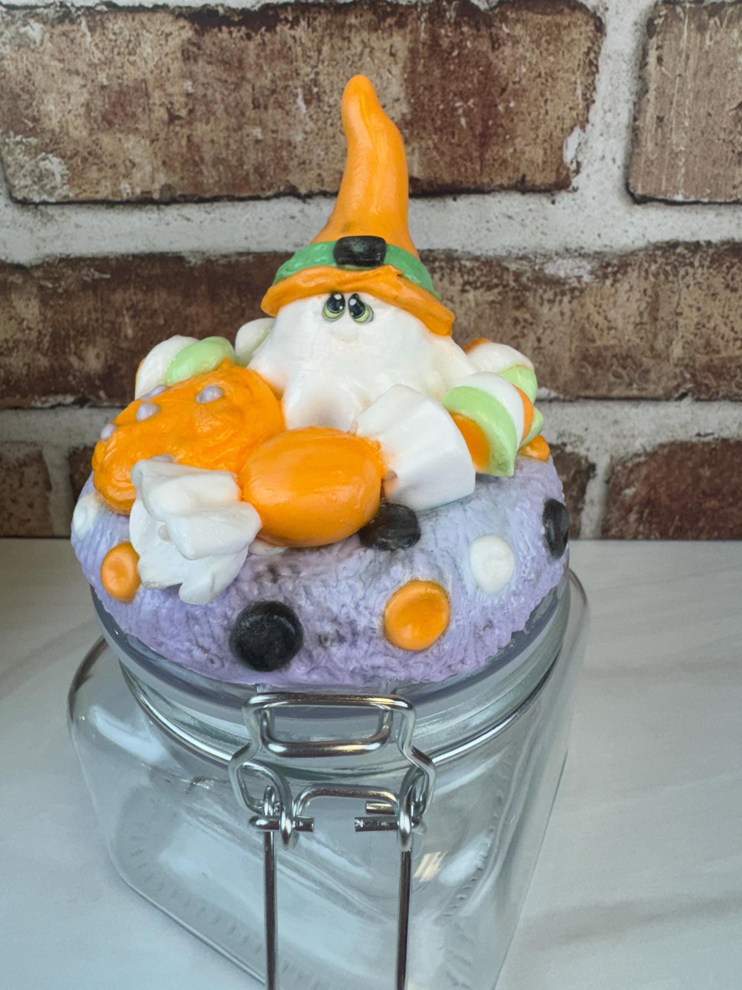 Spooky sweet treat jar with Halloween ghost and candy decorations on lid