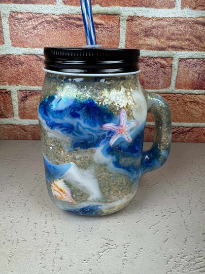 Seashell mason jar mug with beach-themed ocean design and straw for coastal drinkware enthusiasts