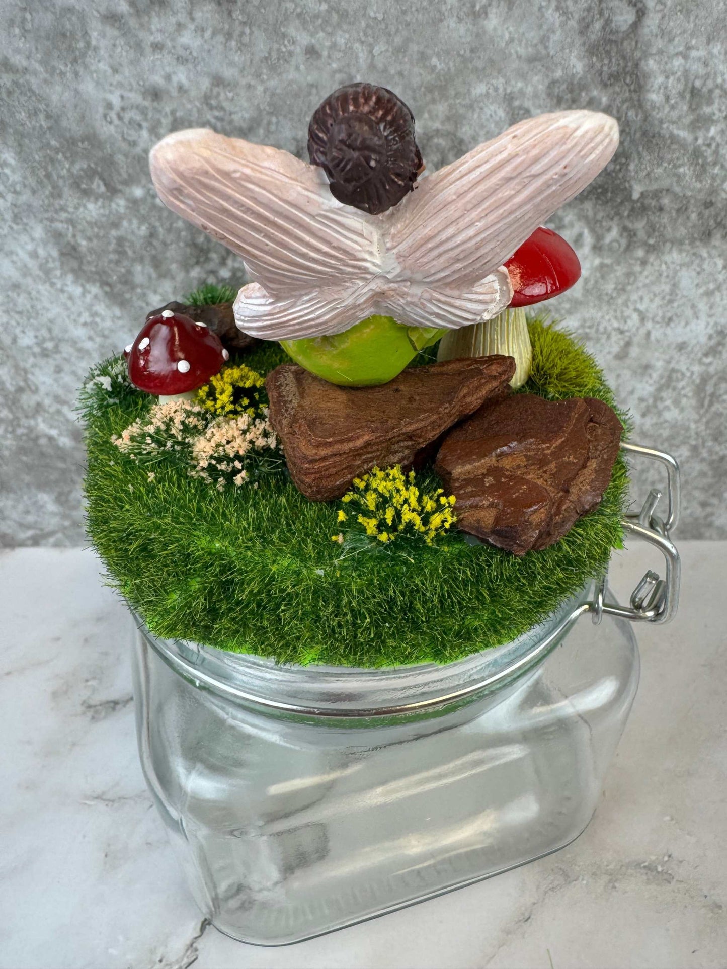 Magical fairy garden themed glass jar with fairy and mushroom decor
