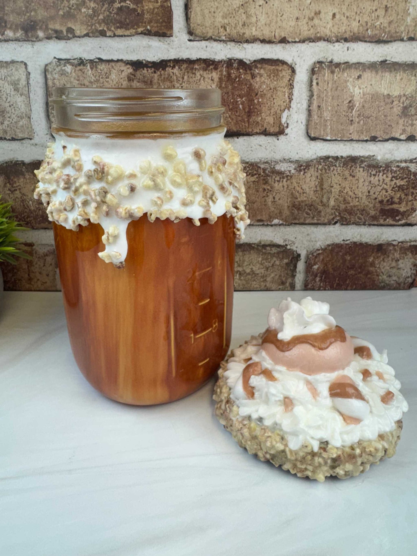 Handmade sweet treat mason jar with faux whipped topping and donut decoration on lid