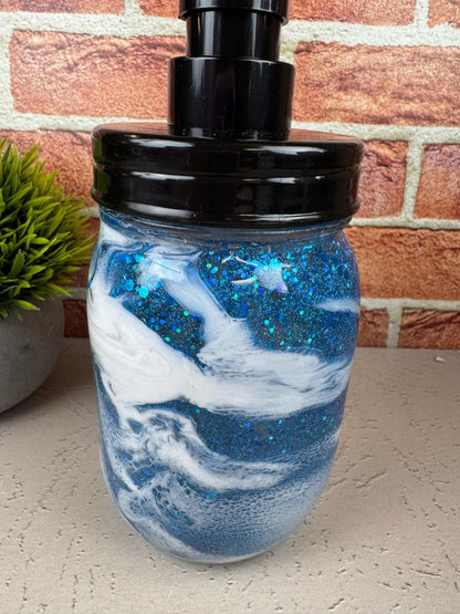 Blue soap dispenser with black pump and sparkly coastal design