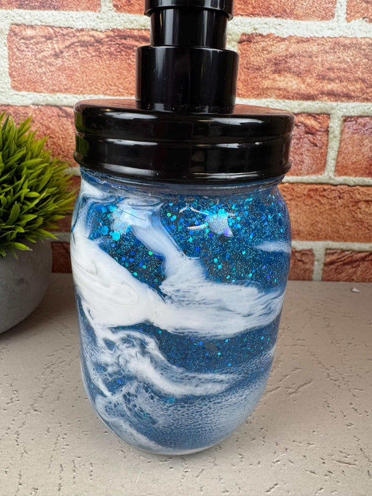 Blue soap dispenser with black pump and sparkly coastal design