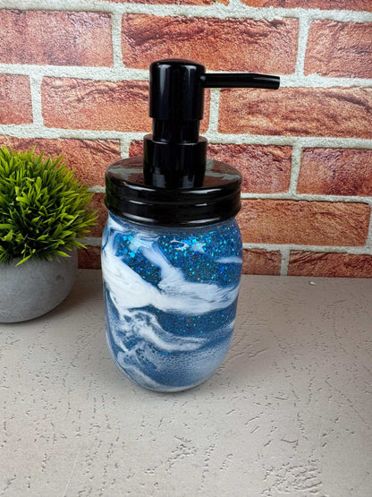 Blue soap dispenser with black pump for coastal bathroom decor