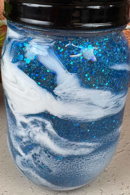 Blue soap dispenser with black pump for coastal bathroom decor