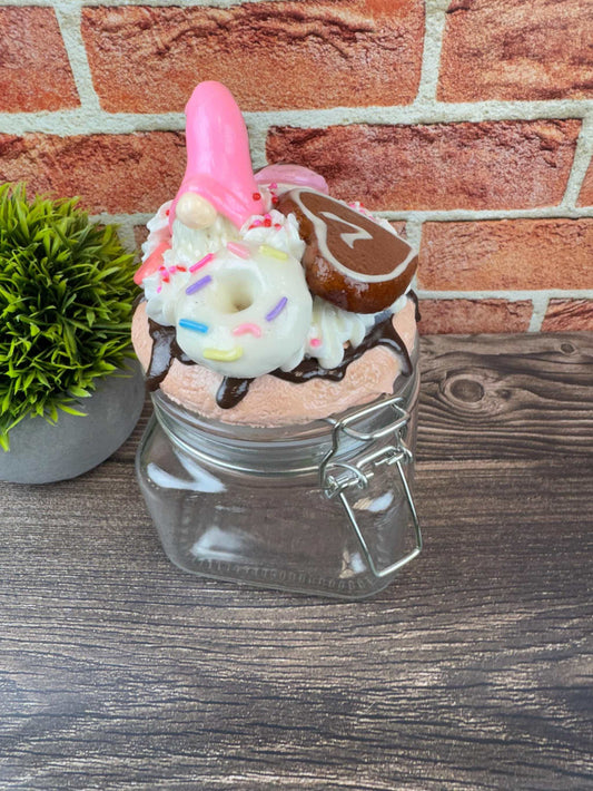 Whimsical sweets jar with gnome lid topped with donut and cookie decorations for kitchen decor