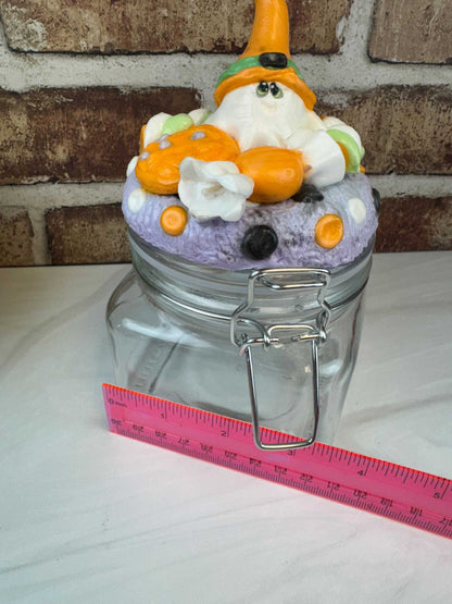 Spooky sweet treat jar with handcrafted Halloween ghost lid holding candies and cookies