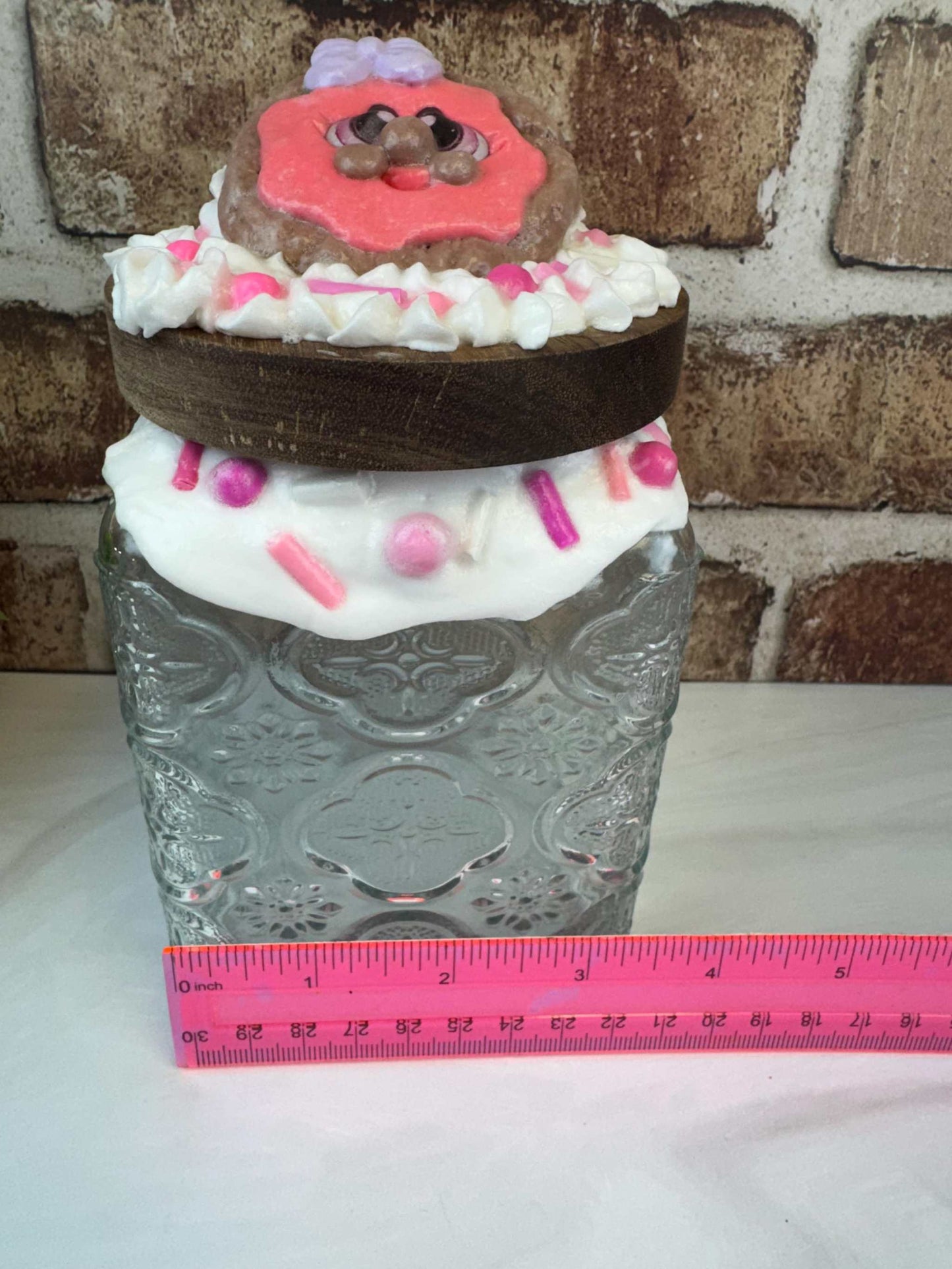 Clear glass faux cookie treat jar with decorative wooden lid topped with hand-painted cookie and colorful sprinkles, whimsical kitchen decor