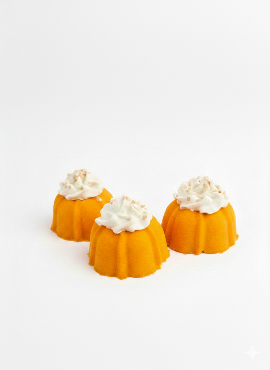 Three small bundt cake bath bombs with bubble frosting on a white background