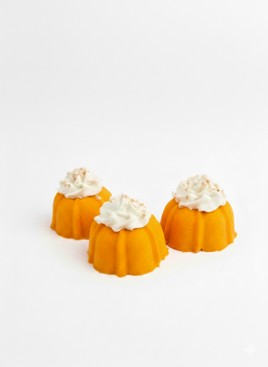 Three small bundt cake bath bombs with bubble frosting on a white background