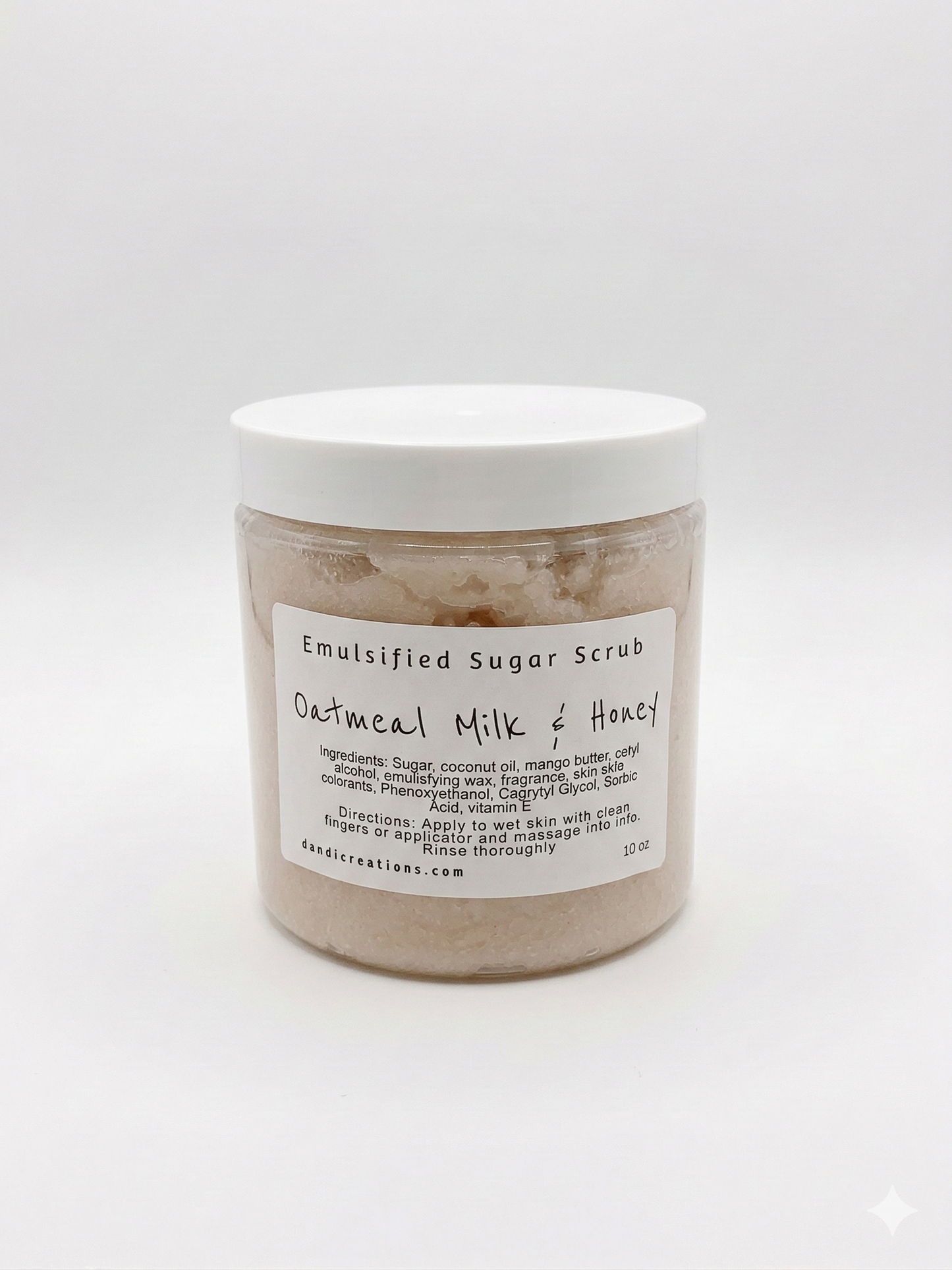 Jar of emulsified sugar scrub with a label on a white background