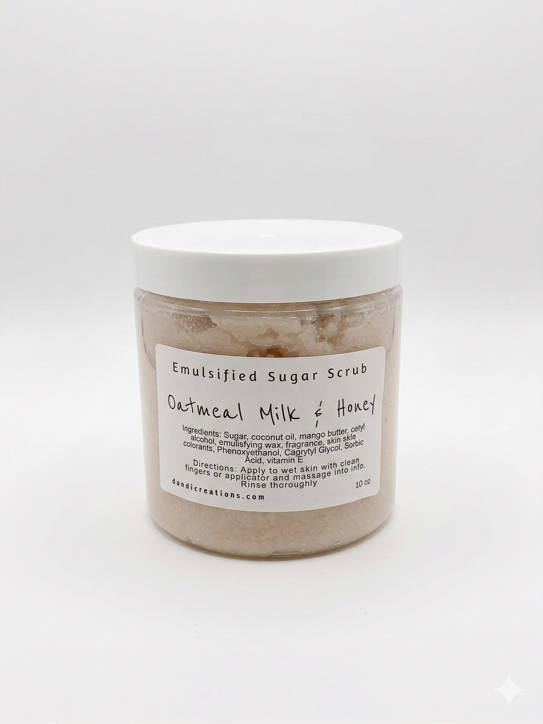 Jar of emulsified sugar scrub with a label on a white background